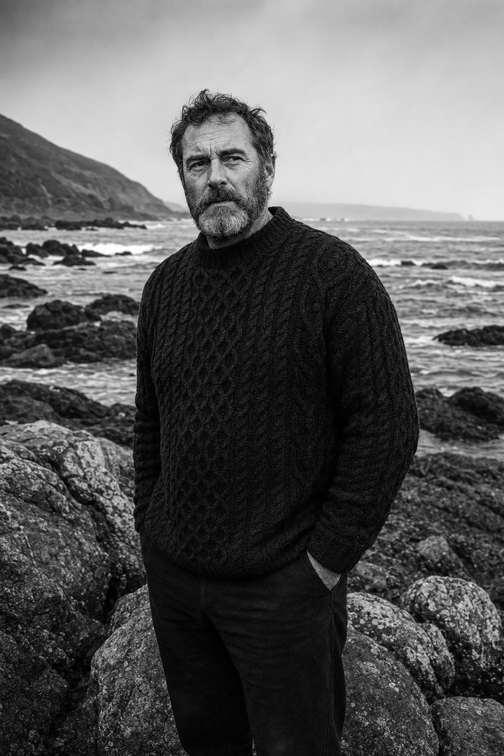John Thomas Donnelly standing on a rocky shoreline